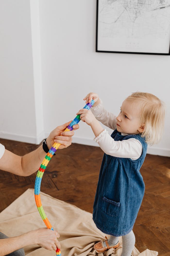 why-choose-us A young girl interacts with a colorful toy indoors, embodying playful learning.
